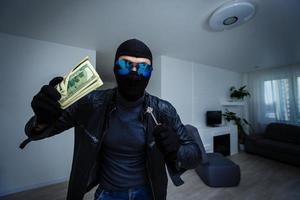 Man burglar stealing tv set from house photo