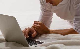 Man working on his laptop at home photo