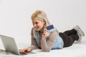 A Happy Woman holding a credit card and shopping from the internet photo