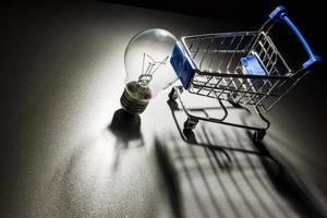 Buy the Light. Shopping cart with light bulb. photo