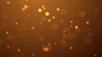 Golden shiny particles floating on abstract background, bokeh particles flying slowly video