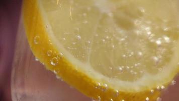 Soda bubbles on a slice of lemon close-up video