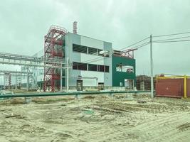 Construction of a new modern industrial building, metal truss frame on a background of blue sky. photo