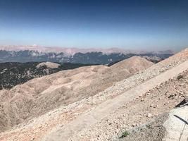 sandy mountains with green plants. beautiful, travel to an exotic country, tourism. mountains under the clouds, trails for tourists, climbing photo