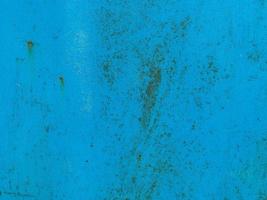 blue texture, metal wall painted in blue paint. the background. traces of corrosion on the metal. rust on texture photo