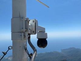 CCTV Camera or surveillance operating with Matterhorn snow mountain in background photo