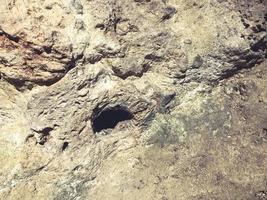 texture. cave made of stone with a hole. wall with scuffs and damage. 3d volumetric texture, background photo