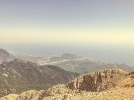 mountains against the blue sky. upland of stones and sand. grass and bushes grow on the mountain. leisure. hiking trails on the mountain, travel to hot countries photo