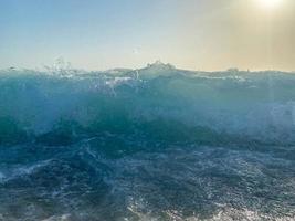 Waves, splashes of water on the beach at the sea on vacation in a tourist warm eastern tropical country southern paradise resort on vacation. The background photo