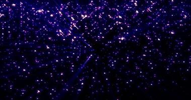 Bright luminous shiny purple beautiful mysterious rhinestone star particles on a black background. Abstract background, intro photo