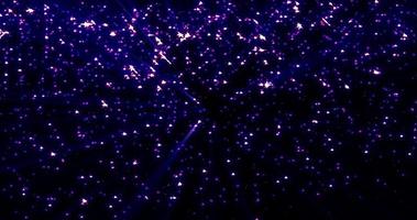 Bright luminous shiny purple beautiful mysterious rhinestone star particles on a black background. Abstract background, intro photo