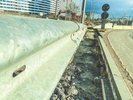 construcción de un nuevo barrio en la ciudad. bloques de hormigón y pilotes se colocan en asfalto, estructuras pesadas para la construcción de carreteras y puentes foto