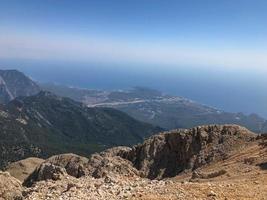 Beautiful landscape view from a high mountain to the forest and mountains in a tropical country with resorts and the sea photo