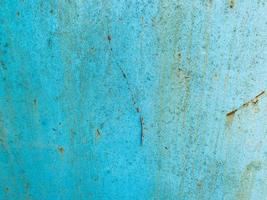 blue texture, metal wall painted in blue paint. the background. peeling, old paint on the metal, traces of corrosion and damage. old texture, retro style photo