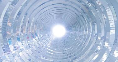 A rotating silver metal chrome shiny tunnel with walls of ribs and lines in the form of a circle with reflections of luminous rays. Abstract background photo