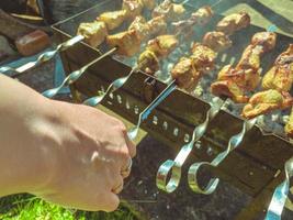 outdoor recreation in the company. barbecue leisure. on the grill skewers with juicy, appetizing meat. natural food, pork kebab, grilled kebab photo