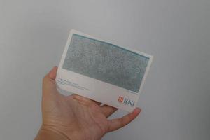 West Java, Indonesia on July 2022. A hand is holding a Bank National Indonesia account book. photo
