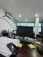 Jakarta, Indonesia in July 2022. An office desk in a project site office, there is a computer monitor along with its keyboard photo
