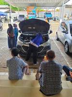 Central Java, Indonesia in October 2022. An officer is carrying out a physical check of a vehicle that will extend or replace its license plate number. photo