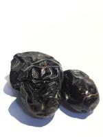 Isolated photo of three ajwa dates. Ajwa dates or also known as Prophetic Dates.
