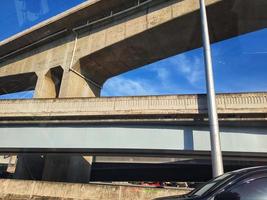 The concrete bridge structure is very sturdy and intersects with other road structures. photo