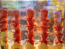 Close up chinese fried sausage on chinese street food stall on walking street photo