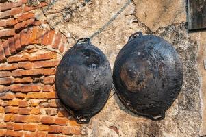 Rust pan hanging on the wall in talad noi.Talad Noi Talat Noi, one of the oldest neighbourhoods in Bangkok, is filled with historic temples, charming shop houses photo