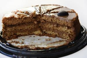 Delicious honey cake close-up. Sliced sweet cake on a white background. Slices of honey cake for the holiday. photo