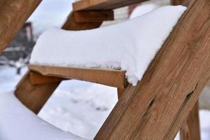 Wooden stairs at the house in the snow in winter. Beautiful staircase in the snow. Snow on the steps. photo