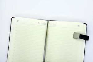 Grey leather notebook on a white background. Notebook close-up. An open notebook. photo