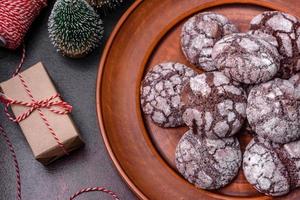 Delicious fresh brownies with Christmas decorations on a dark concrete background