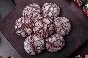 Delicious fresh brownies with Christmas decorations on a dark concrete background photo