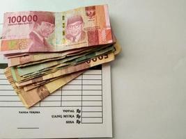 blank notes and rupiah notes on it photo