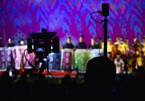 Movie camera in shadow, blurred background, show stage photo