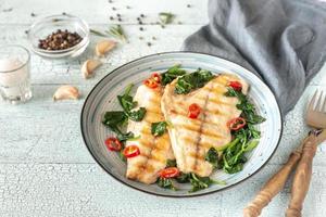 Grilled sea bream fish fillet with spinach photo