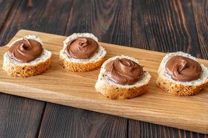 Slices of baguette with chocolate paste photo