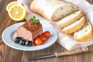 Chicken liver pate on the white plate photo