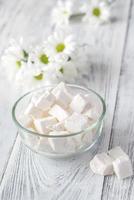 Bowl of white lump sugar photo