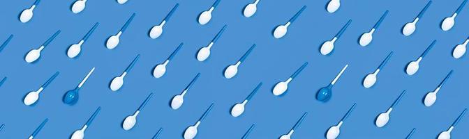 Plastic spoons on blue background. photo