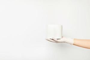 Toilet paper lying on a woman's hand wearing a glove. photo