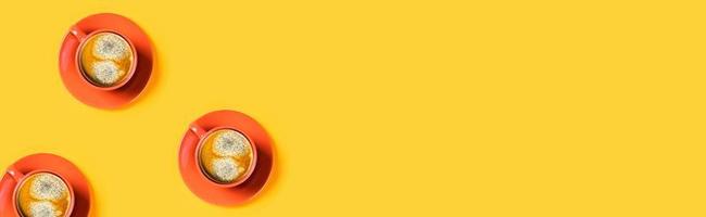 One cup of coffee on yellow background. photo