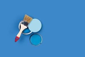 Brush and pain can on a blue background. photo