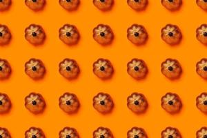 Halloween pattern of skeletons on orange background. photo