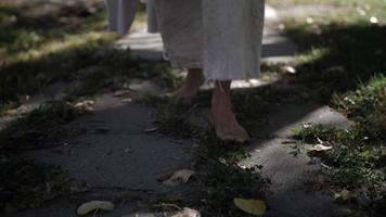 Feet Of Robed Man Walking In Slow Motion video