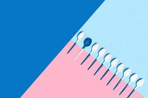 Plastic spoons on tricolor background. photo