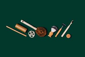 Zero waste accessories on green background. photo