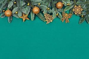 Christmas green background with golden toys. photo