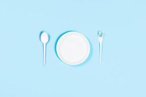 Blue background with plastic utensils. photo