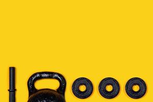 Kettlebells and dumbbells on color background. photo