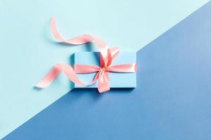 One gift box on a color background. photo